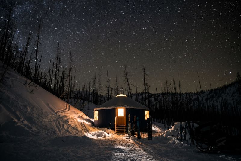 Alpine Yurt exterior at night under a clear sky full of stars
